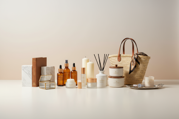 Create a premium hero banner image for the homepage of my dropshipping store Luxuvo.
Requirements:

Full-width, high-resolution, suitable for desktop and mobile.

Include all product types from my store: Home Essentials and Lifestyle & Beauty.

Each product should clearly display my Luxuvo logo subtly but visibly.

Arrange the products in a clean, professional composition: some angled, some upright, natural spacing, with realistic shadows and reflections for depth.

Use a neutral, luxury-style background (w